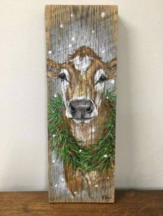 a painting of a deer wearing a christmas wreath on it's head and nose