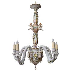 an ornate chandelier with angel figurines on it