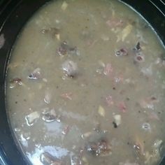 a pot filled with soup sitting on top of a stove