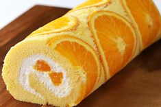 an orange roll on a cutting board with slices cut out and ready to be eaten