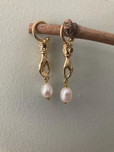 14k gold plated, cz accented hand charms, suspending AAA quality baroque freshwater pearls. On 14k gold plated huggie half hoops