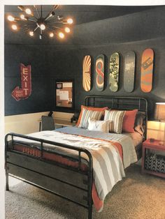 a bed room with a neatly made bed and skateboards on the wall