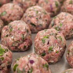 several balls of meatballs with herbs on them