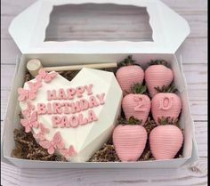 a birthday cake in a box with pink decorations