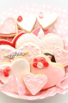 some heart shaped cookies on a pink plate