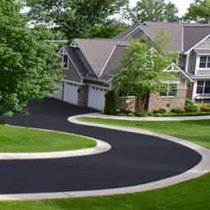 an aerial view of a residential neighborhood with driveways and trees