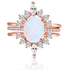 a white opal and diamond ring with rose cut diamonds on the side, set in 18k gold