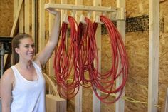 a woman is holding up some red cords