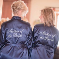 two women in robes that say mother of the bride and mother of the groom on them