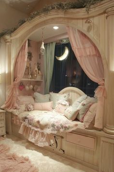 a bedroom with pink curtains and pillows on the bed