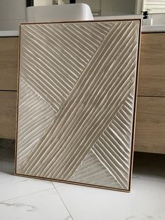 a bathroom with a white sink and large mirror on the wall next to it's tiled floor