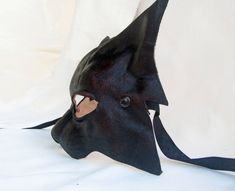 CAT MASK IN DARK LEATHER This item is available to order. Please allow three weeks before shipping. Our masks are made entirely by hand, all in genuine leather and wearable. The masks are designed not only as art objects, but also to be worn. Thanks to our special process the leather retains its elasticity allowing a good fit of the mask. The leather we luse is tanned using vegetable products. The casts of which are shaped masks are in clay and its are designed and produced by us. Thanks a lot f Black Cosplay Costume For Masquerade, Black Cosplay Costume For Masquerade Events, Black Fantasy Costume Accessories For Larp, Black Cosplay Costume For Masquerade And Cosplay Events, Black Fantasy Masks And Prosthetics For Cosplay, Black Cat Ears Fantasy Costume Accessories, Black Fantasy Cat Ears Costume Accessories, Black Elven Costume For Costume Party, Black Masquerade Cosplay Costume With Mask