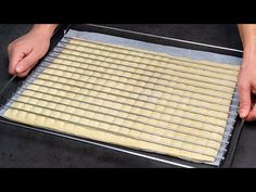 a person is placing dough on a baking sheet to bake them in the oven