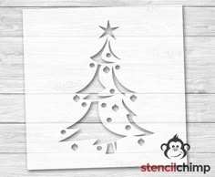 a cutout of a christmas tree on a wooden background with the words stencil chimp