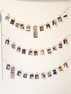 a white wall with pictures hanging on it