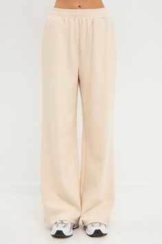 Step up your lounge game with our chic wide knit pants. These pants are sure to become your new favorite, whether you're relaxing at home or running errands. The wide leg and knit fabric give them a stylish look, while the beige cream hue makes them easy to pair with any top. Plus, they're so comfortable you'll never want to take them off! Wide pants Knit Elastic at waist Shell: 55% Cotton 43% Polyester 2% Spandex JJ941P XS Height 5'9" / (175cm) / Bust 34" / (86cm) / Waist 26â€(67cm) / Hip 35â€ Beige Comfortable Bottoms With Soft Texture, Comfortable Beige Bottoms With Soft Texture, Comfortable Beige Bottoms With Ribbed Waistband, Comfortable Beige Pants For Lounging, Beige Full Length Lounging Pants, Casual Beige Bottoms With Soft Texture, Relaxed Beige Bottoms For Loungewear, Beige Casual Wide Leg Loungewear Pants, Beige Pants For Loungewear