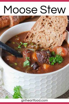 a white bowl filled with soup and bread