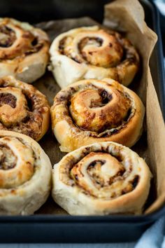 several cinnamon rolls in a baking pan ready to be baked into the oven for dinner