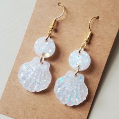 Handmade White Rainbow Glitter Sparkle Glow In The Dark Boho Sea Shell Drop Dangle Earrings! Soo Beautiful. Best Described As An Opal Color. Added Lots Of Sparkly Glow Glitters And I Made It An Overall Blue Glow For The Whole Thing. Had Two Parts With A Circle And A Small Shell. Lightweight. Gold Hardware. Hooks Are Hypoallergenic. These Are Amazingg. I Made Me Some And Immediately Made Another Batch Because I Thought They'd Be Perfect For Summer Festivals Or The Beach!! Happy To Answer Any Ques White Resin Jewelry For Parties, White Glitter Earrings For Party, White Glitter Party Earrings, White Glitter Jewelry Gift, White Glitter Jewelry As Gift, White Glitter Jewelry For Gifts, Dark Boho, Rainbow Sparkle, Dark Sea