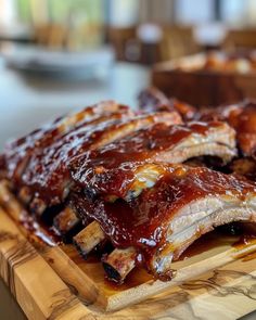 ribs covered in bbq sauce on a cutting board