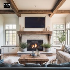 a living room filled with furniture and a flat screen tv mounted above the fire place