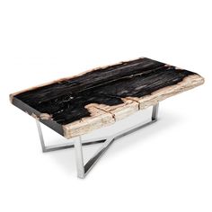 a wooden table with metal legs and a black wood slab on the top that has been cut in half