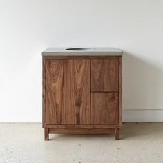 a bathroom sink sitting on top of a wooden cabinet