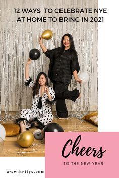 two women in black and white outfits posing for a photo with balloons, streamers and confetti