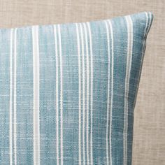 a blue and white striped pillow sitting on top of a couch