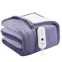 an electric blanket is plugged in to the wall with a remote control on it