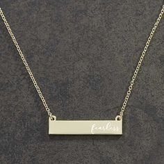 Personalized with any one-line message engraved across the necklace in your choice of font and alignment Nameplate is approximately 1.5" end to end17" chain with 3.5" extender for optional extra lengthPearl bead accent at the end of extenderConstructed of 10KG plated steelItem is packaged in a velvet pouch, ready for gift givingImported Our celebrity inspired You Name It Personalized Nameplate Necklace is the perfect modern piece of jewelry to top off her trendy look, the perfect gift for brides Name Pendant Gold, Gold Nameplate Necklace, Personalized Nameplate Necklace, Xo Necklace, Nameplate Necklace Gold, Diamond Bar Necklace, Diamond Initial Necklace, Blue Sapphire Necklace, Dainty Diamond Necklace