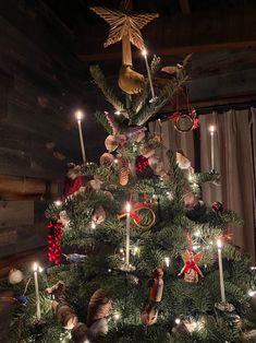 a decorated christmas tree with candles and ornaments