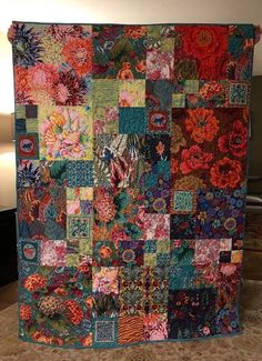 a colorful quilt is hanging on the wall