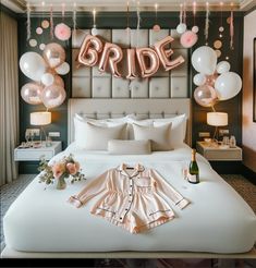 a bed room with a neatly made bed and balloons