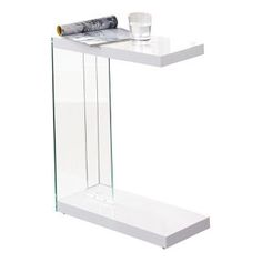 a white table with a glass shelf holding a rolled up piece of paper and a cup on it