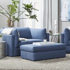 a blue couch and ottoman in a living room