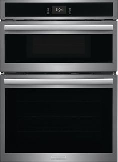 two ovens side by side with the door open