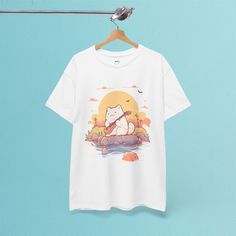 ✦ OUR PRODUCT Get ready to rock a super cute look with our Kawaii Cat Play Guitar T-Shirt! It's got a sweet cat playing the guitar with a beautiful sunset in the background. This T-shirt is just right for anyone who loves cats, music, or just cool Japanese style tees. Wear it when you're chilling out or give it as a cute gift to a cat-loving friend. It's all about good vibes and smiles with this one!  ✦ GARMENT DETAILS * 100% US cotton  * DTG printing * Fabric weight :5.0-5.3 oz/yd² (170-180 g/m Kawaii T Shirts, Harajuku Fashion Kawaii, Japanese Harajuku Fashion, Mode Harajuku, Sunset Shirt, Chat Kawaii, Playing The Guitar, Fashion Kawaii, Sweet Cat