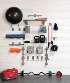 there is a gym room with equipment on the wall