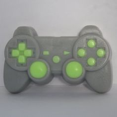 a close up of a video game controller on a white surface with green circles around it