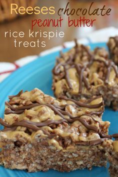 two pieces of chocolate peanut butter rice krispy treats on a blue plate with the rest of the dessert in the background