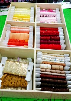 an assortment of different colored threads in a box