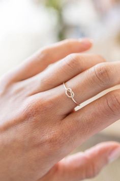 Love knot rings have a deep history throughout the ages and throughout various parts of the world. This dainty ring is a simplified version and features a minimalist knot, perfect for stacking or to be worn on its own.  Made from .925 sterling silver wire, it is water-resistant and will be a piece that lasts. Each piece is custom-made for you, so please allow 1-5 days for the jewelry to ship. - 14/20 Gold Filled  - 1.1mm band - Handmade to order in our studio in Salt Lake City, UT - Comes neatly packaged in a kraft jewelry box ready for gifting Knot Rings, Dainty Promise Ring, Love Knot Ring, Zierlicher Ring, Knot Ring, Love Knot, Ring Dainty, Dainty Ring, Ring Ring