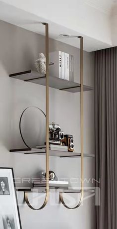 a shelf with some books on top of it next to a window in a living room