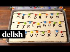 a cake that has been decorated with letters and lights