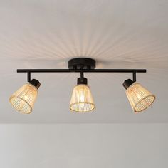 three lights are hanging from the ceiling in a room