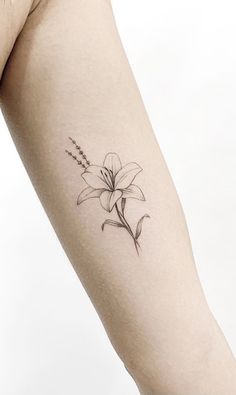 a woman's arm with a flower tattoo on the left side of her body