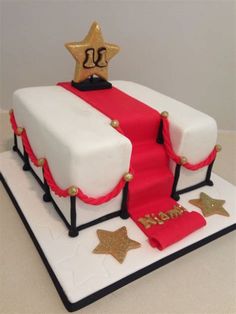 a cake that is decorated with red, white and gold