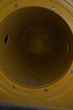 the bottom of a yellow object with holes in it