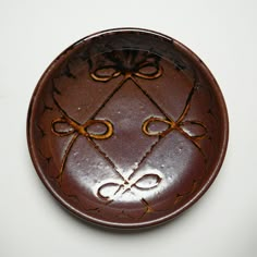 a decorative brown plate with scissors on it